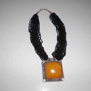 Multi Strand Black Bead Necklace with Large Amber Pendant